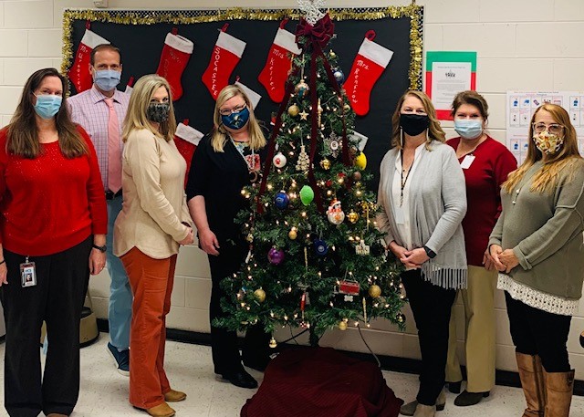 Guidance Department Members surround the Angel Tree, which students raised money for.