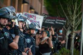 Police officers stand guard to make sure protesters do not disturb the community.