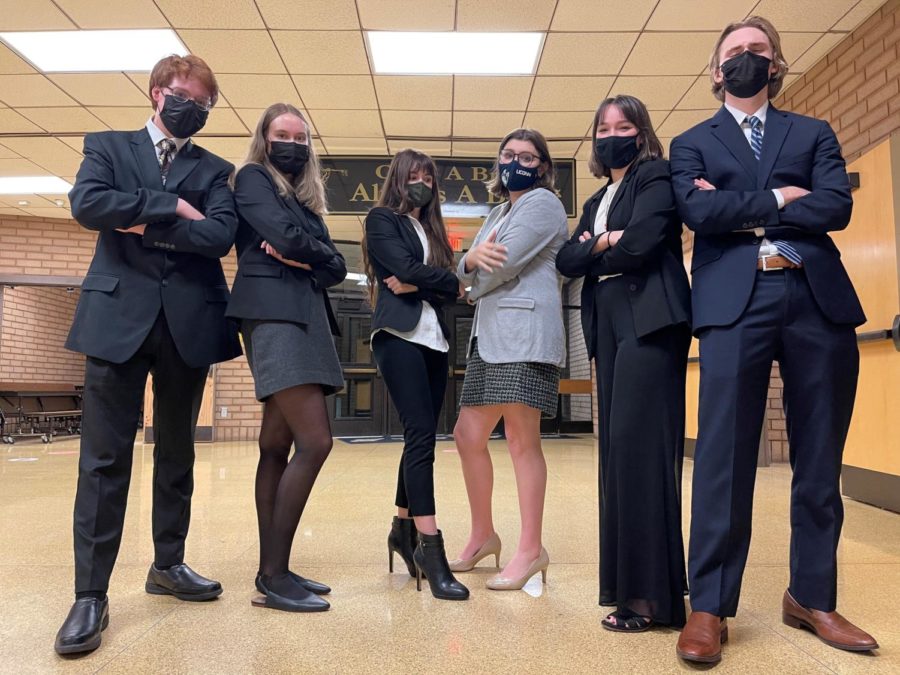 The+Mock+Trial+Team+stands+ready+to+compete+in+attorney+attire.