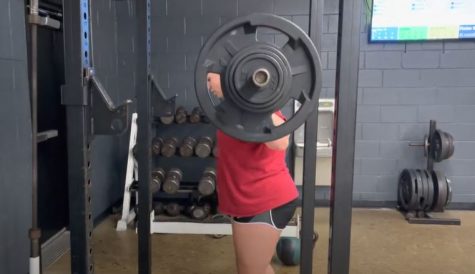 Junior Hailey Rappeno squats during weightlifting class.