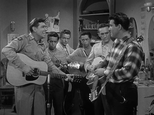 A scene from Episode 19, Season 1, of The Andy Griffith Show, Andy suspects that Barney and a few other citizens have been taken in by a slick music-recording man from out of town.