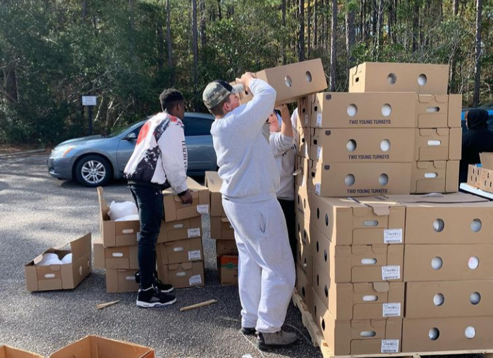 Justin Pergolizzi and Jay DeLosSantos unpack Turkeys for the Thanksgiving distribution at the Church of the Resurrection.