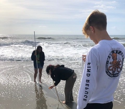 Seniors Brianna Lazar and Max Davis perform a beach profiling lab to study the beach dynamics that affect waves and currents at Pebble Beach, Myrtle Beach.