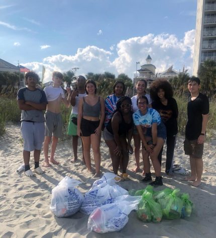 Ocean Club students pose behind some of the 14 bags of trash  they found at Springmaid Pier.