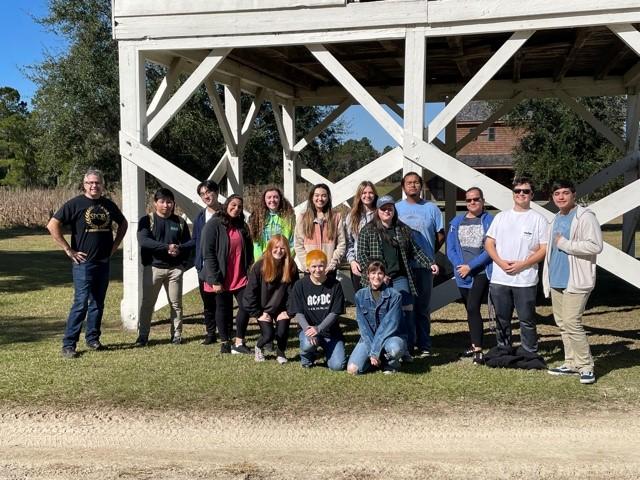 Mr. Boyle stands with IB History students on a trip to Mansfield Plantation, which he wrote a book about.