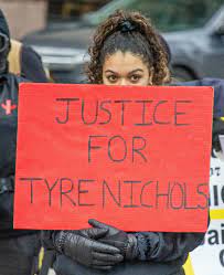  A protestor holds a sign at the Ohio State House in Columbus, Ohio