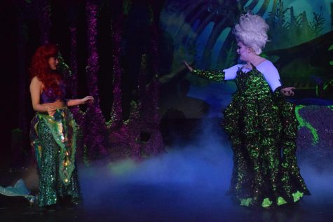Lily McLendon portrays Ursula onstage, speaking to Ariel (Mattie Washburn).