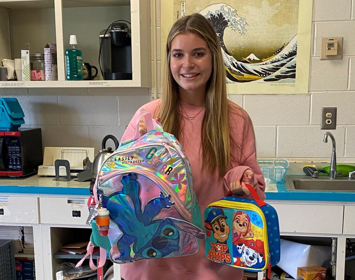 Senior Ava Boeth carries the childrens backpack and lunchbox she bought for senior year. 
