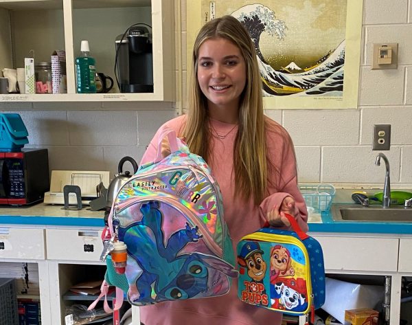 Senior Ava Boethe carries the childrens backpack and lunchbox she bought for senior year. 