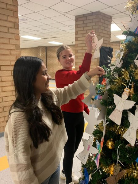 Sophomores Paola Rodriguez-Morales and Addison Morales hang angels bought by their Honors Chemistry class.
