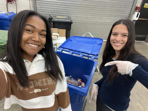 Ocean Club members Jenae Marshall and Maria Soares de Almeida collect recyclables around the school.