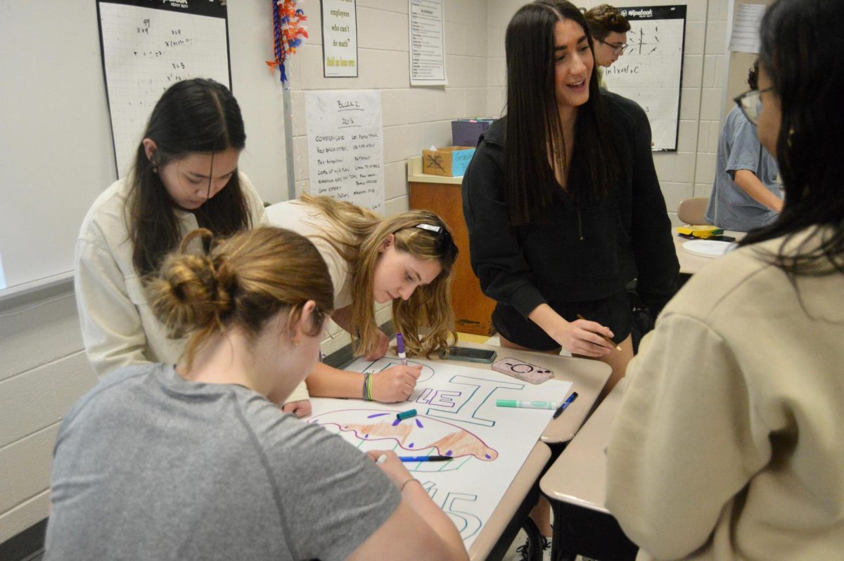 Students work together on Pi posters for Mu Alpha Theta