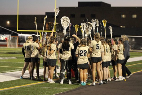 JV Womens Lacrosse Coach Hailey Rappeno motivates her team in the huddle.