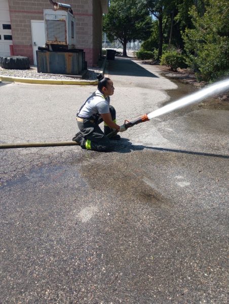 Rachel Hernandez learns to use a hose as part of the Junior Firefighter Program.