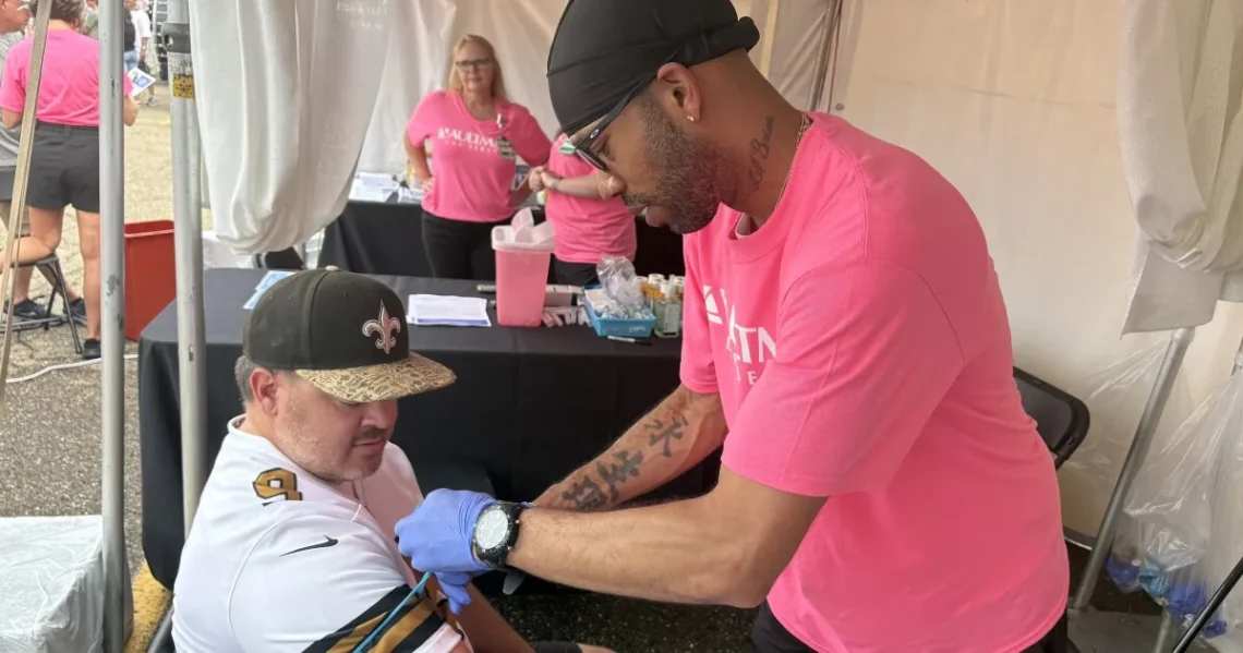 People receive free blood draws for prostate and heart screenings outside the Pro Football Hall of Fame