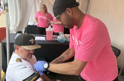 People receive free blood draws for prostate and heart screenings outside the Pro Football Hall of Fame