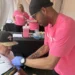 People receive free blood draws for prostate and heart screenings outside the Pro Football Hall of Fame